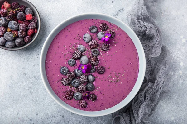 delicious blueberry smoothie bowl with frozen berries. Healthy vegan raw food. top view