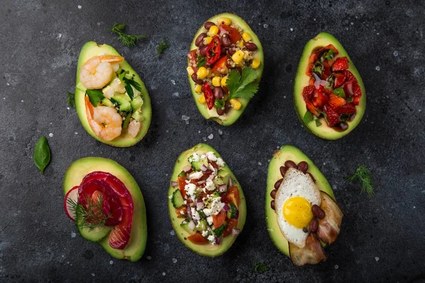 Avocado Halves Stuffed Different Toppings Dark Background Top View — Stock Photo, Image