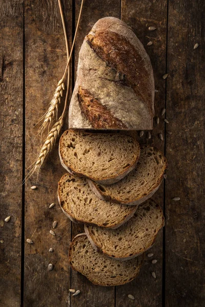 Gesneden Zelfgebakken Brood Met Zonnebloempitten Houten Achtergrond Bovenaanzicht — Stockfoto