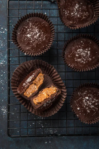 chocolate cups with salted caramel and nuts, top view