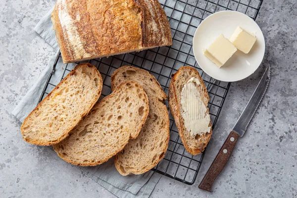 Slices of freshly baked homemade sour dough bread with butter — Stock Photo, Image