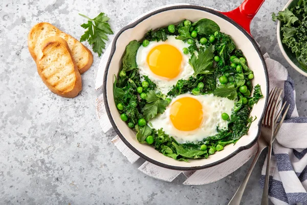 Fried eggs with kale, spinach and green peas for breakfast — Stock Photo, Image