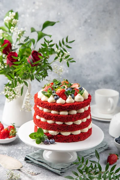 festive  Red Velvet cake on white cake stand