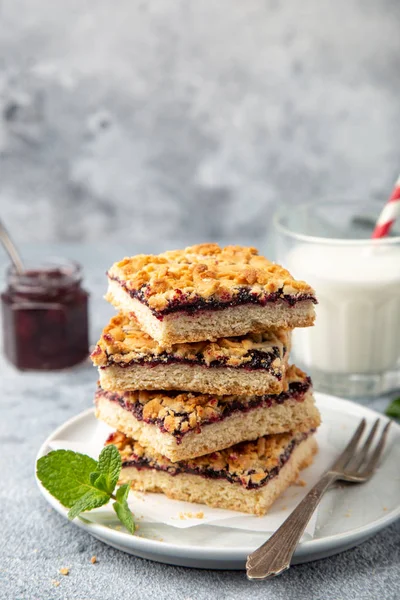 Berries jam squares and glass of milk — Stock Photo, Image