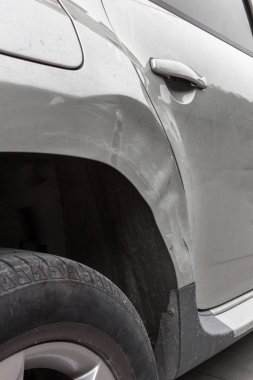Closeup Dented car. Side body of car was damaged by accident in traffic. clipart