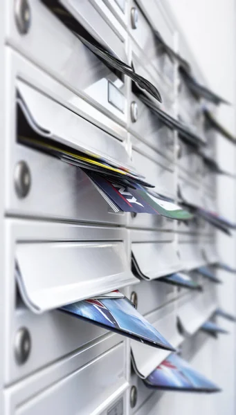 Mailboxes filled of leaflets. Concept of spam and junk mail.