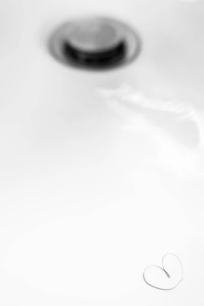Heart-shaped pubic hair in a sink out of focus. Ideal for concepts, events and backgrounds. — Stock Image Heart Shaped Pubic Hair Sink Out Focus Ideal Concepts Events Stock Photo