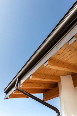Rain gutter on the roof ecological house clipart