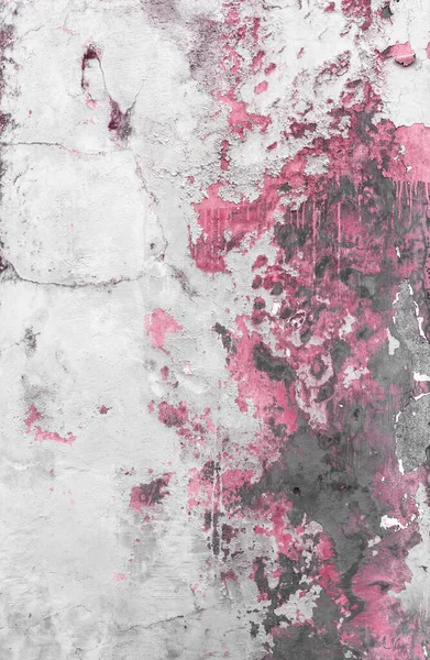 Pink peeled paint. Texture of grungy wall with pink paint peeling off.