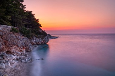 Lefkada, Yunanistan. Agois Ioannis bölgesinde küçük bir sahilde nefes kesici bir gün batımı..