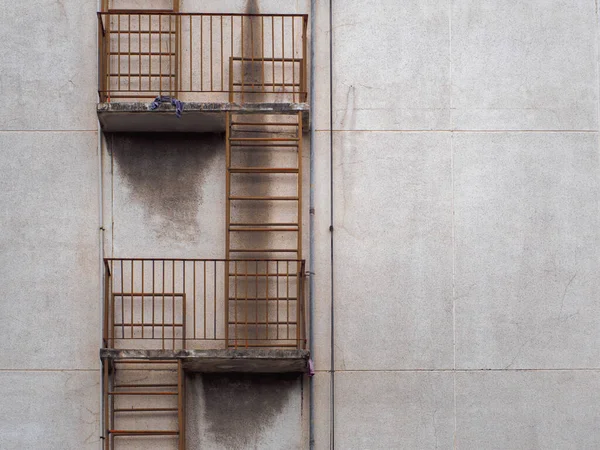 Fire exit ladder outside the building. Old fire escape installed outside the old apartment.