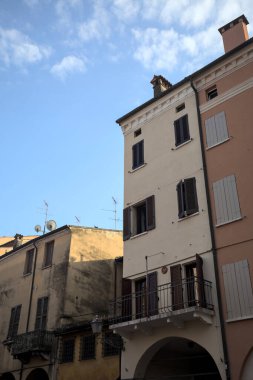 Facades with balconies of buildings in an italian town at sunset