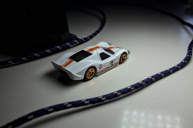 Mantova, Italy - 10TH AUGUST 2025 - Hot Wheels replica of a 1967 Ford GT40 MK IV pretending to make a curve during a race on a circuit