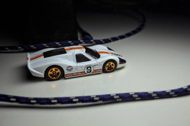 Mantova, Italy - 10TH AUGUST 2025 - Hot Wheels replica of a 1967 Ford GT40 MK IV pretending to make a curve during a race on a circuit