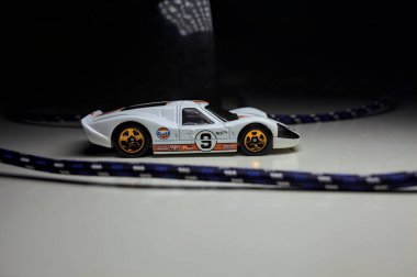 Mantova, Italy - 10TH AUGUST 2025 - Hot Wheels replica of a 1967 Ford GT40 MK IV pretending to make a curve during a race on a circuit