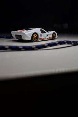 Mantova, Italy - 10TH AUGUST 2025 - Hot Wheels replica of a 1967 Ford GT40 MK IV pretending to make a curve during a race on a circuit
