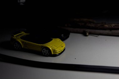 Mantova, Italy - 10TH AUGUST 2025 - Hot Wheels replicas of a black Nissan Skyline GT-R R32 and a yellow 1990 Acura NSX pretending to drift during a race on a mountain pass