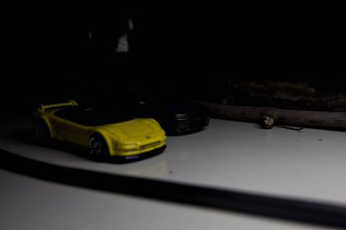 Mantova, Italy - 10TH AUGUST 2025 - Hot Wheels replicas of a black Nissan Skyline GT-R R32 and a yellow 1990 Acura NSX pretending to drift during a race on a mountain pass
