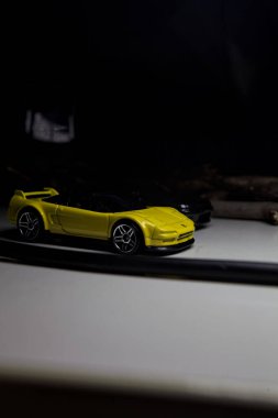 Mantova, Italy - 10TH AUGUST 2025 - Hot Wheels replicas of a black Nissan Skyline GT-R R32 and a yellow 1990 Acura NSX pretending to drift during a race on a mountain pass