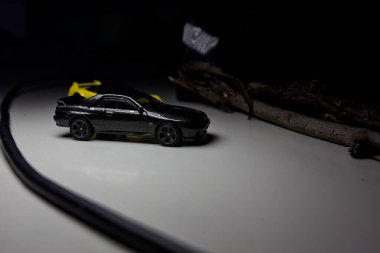 Mantova, Italy - 10TH AUGUST 2025 - Hot Wheels replicas of a black Nissan Skyline GT-R R32 and a yellow 1990 Acura NSX pretending to drift during a race on a mountain pass