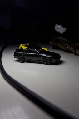 Mantova, Italy - 10TH AUGUST 2025 - Hot Wheels replicas of a black Nissan Skyline GT-R R32 and a yellow 1990 Acura NSX pretending to drift during a race on a mountain pass