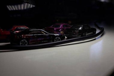 Mantova, Italy - 10TH AUGUST 2025 - Hot Wheels replicas of various Nissan Skyline models from 80s and 90s parked on a passing place of a mountain pass at night