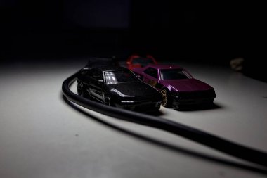 Mantova, Italy - 10TH AUGUST 2025 - Hot Wheels replicas of various Nissan Skyline models from 80s and 90s parked on a passing place of a mountain pass at night