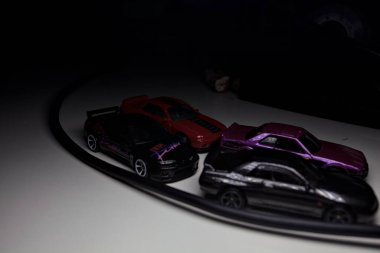 Mantova, Italy - 10TH AUGUST 2025 - Hot Wheels replicas of various Nissan Skyline models from 80s and 90s parked on a passing place of a mountain pass at night