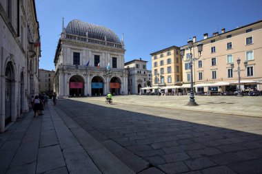 Brescia, Italy - 1ST AUGUST 2025 - Town hall in the Loggia palace in Loggia square on a sunny day with people walking by it