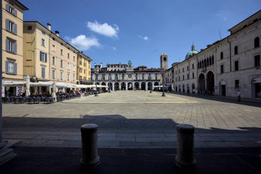 Brescia, Italy - 1ST AUGUST 2025 - Clock tower and its facade in the Loggia square on a sunny day