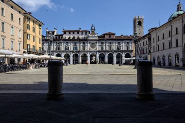 Brescia, Italy - 1ST AUGUST 2025 - Clock tower and its facade in the Loggia square on a sunny day
