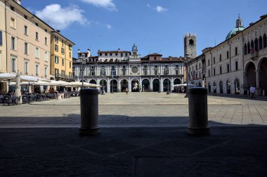 Brescia, Italy - 1ST AUGUST 2025 - Clock tower and its facade in the Loggia square on a sunny day