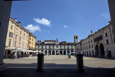 Brescia, Italy - 1ST AUGUST 2025 - Clock tower and its facade in the Loggia square on a sunny day