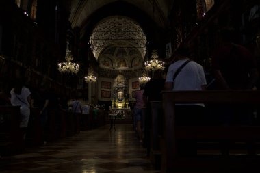 Grazie sul Mincio, Italy - 15TH AUGUST 2025 - Nave in the sanctuary of Holy Mary of Mercy during the Mass for the Assumption of Mary with priests walking between the rows of benches