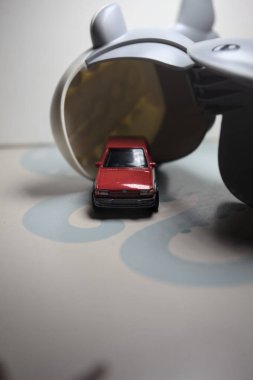 Mantova, Italy - 21ST AUGUST 2025 - Hot Wheels replica of a red 1982 Ford Fiesta MkII right outside the mouth of a toy whale in the act of eating it