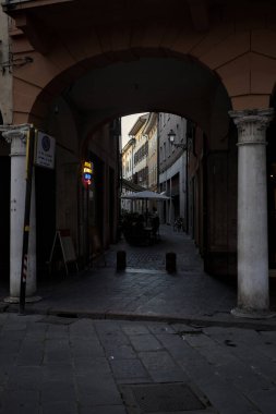 Mantova, Italy - 21ST AUGUST 2025 - Street and porch with the entrance of an alley in an opening of the building