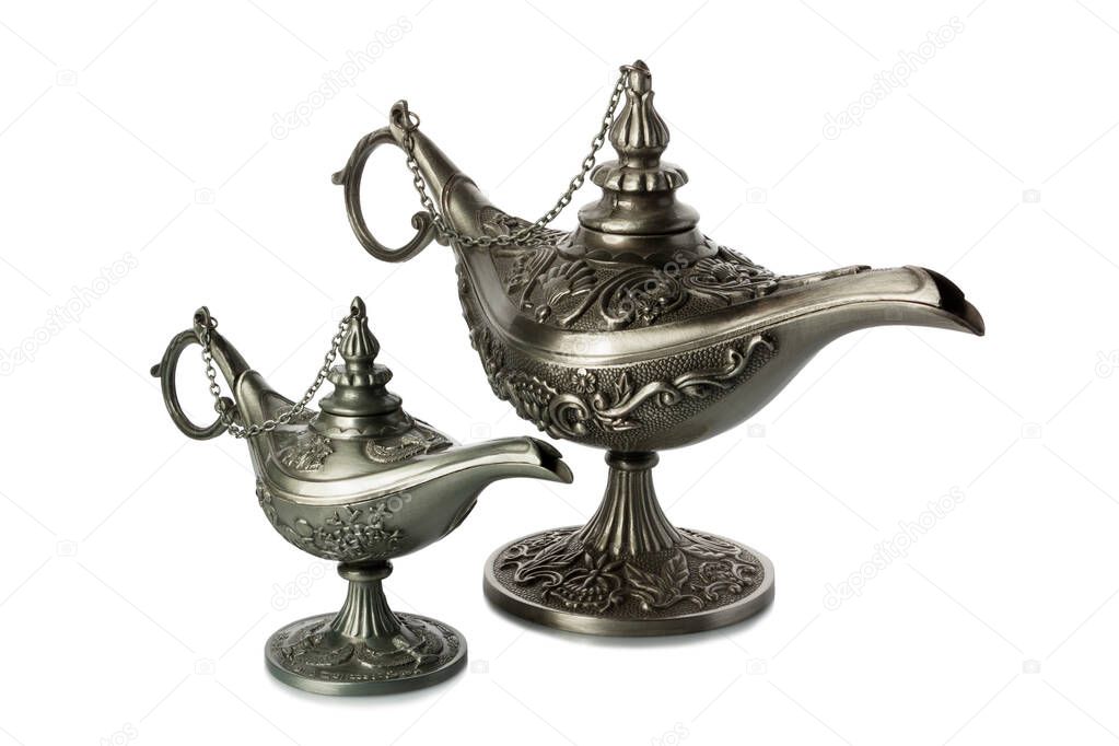 Two oil lamps in oriental style made of metal with krsivym bas-relief on a white background.