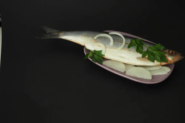 Herring is whole, undivided with onion and parsley close-up. — Stock Photo, Image