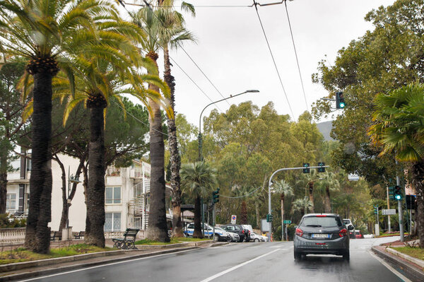 San Remo, Italy - 24 February, 2018. Green part of the city.  View from the car on the roads and the city.