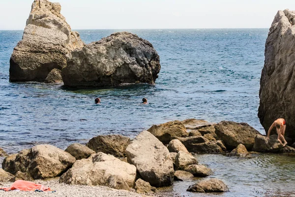 La gente nada entre las rocas . — Foto de Stock