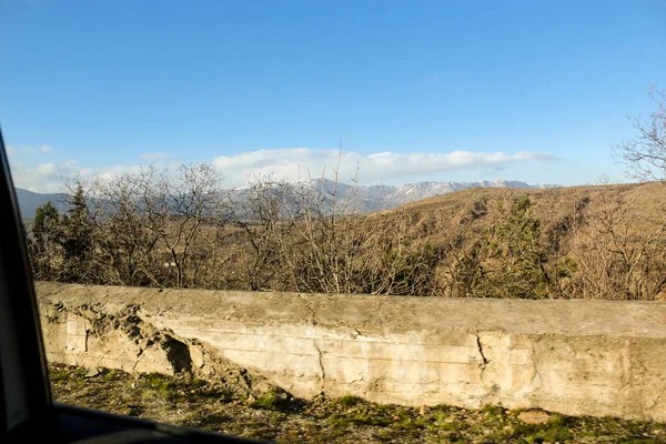 Concrete barrier along the road.