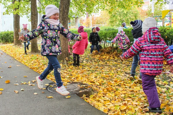 Anak-anak senang dengan dedaunan musim gugur . — Stok Foto
