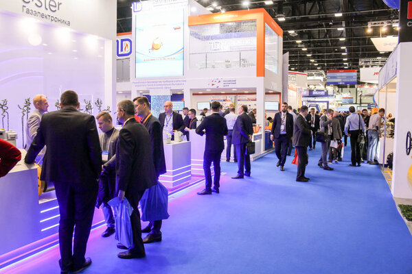 Business people among the stands of companies.