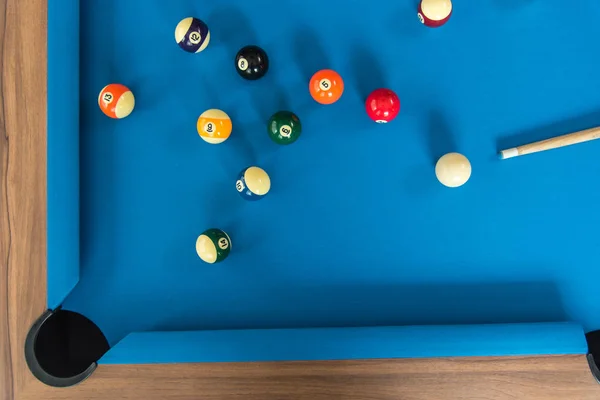 top view of pool or billiards balls on light blue table