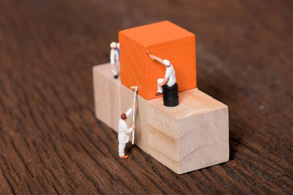 miniature people worker painting wood cube building block , wood