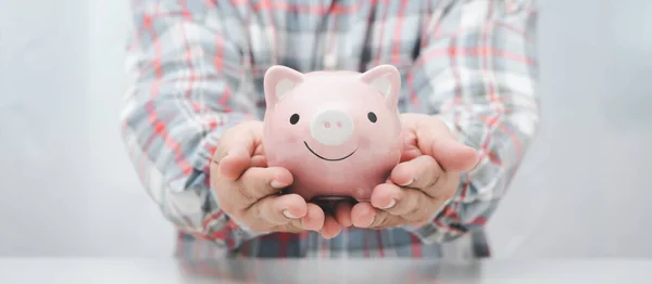 worker hand offer piggy bank , saving concept