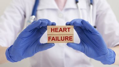 Heart failure concept. HEART FAILURE words inscription on wooden blocks in doctor hands clipart