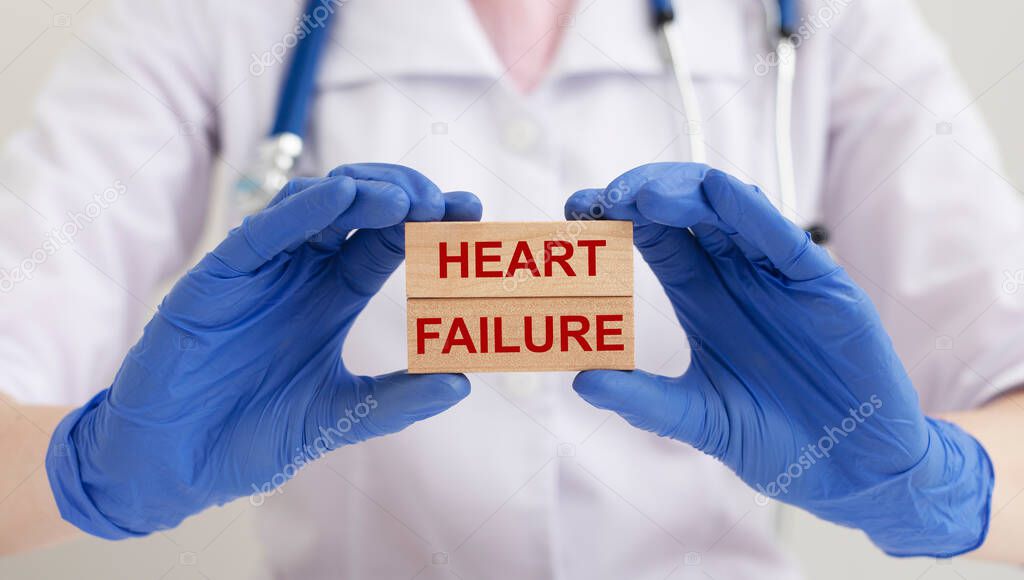 Heart failure concept. HEART FAILURE words inscription on wooden blocks in doctor hands