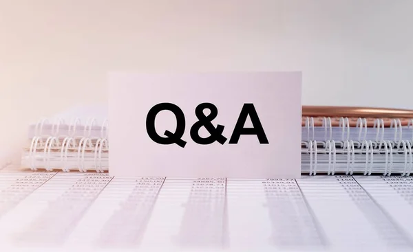 Q and A - Questions and Answers text sign on business white card on office table, faq