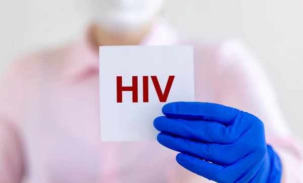 HIV acronym - Human Immunodeficiency Virus - word on paper in doctor hands as medical concept.